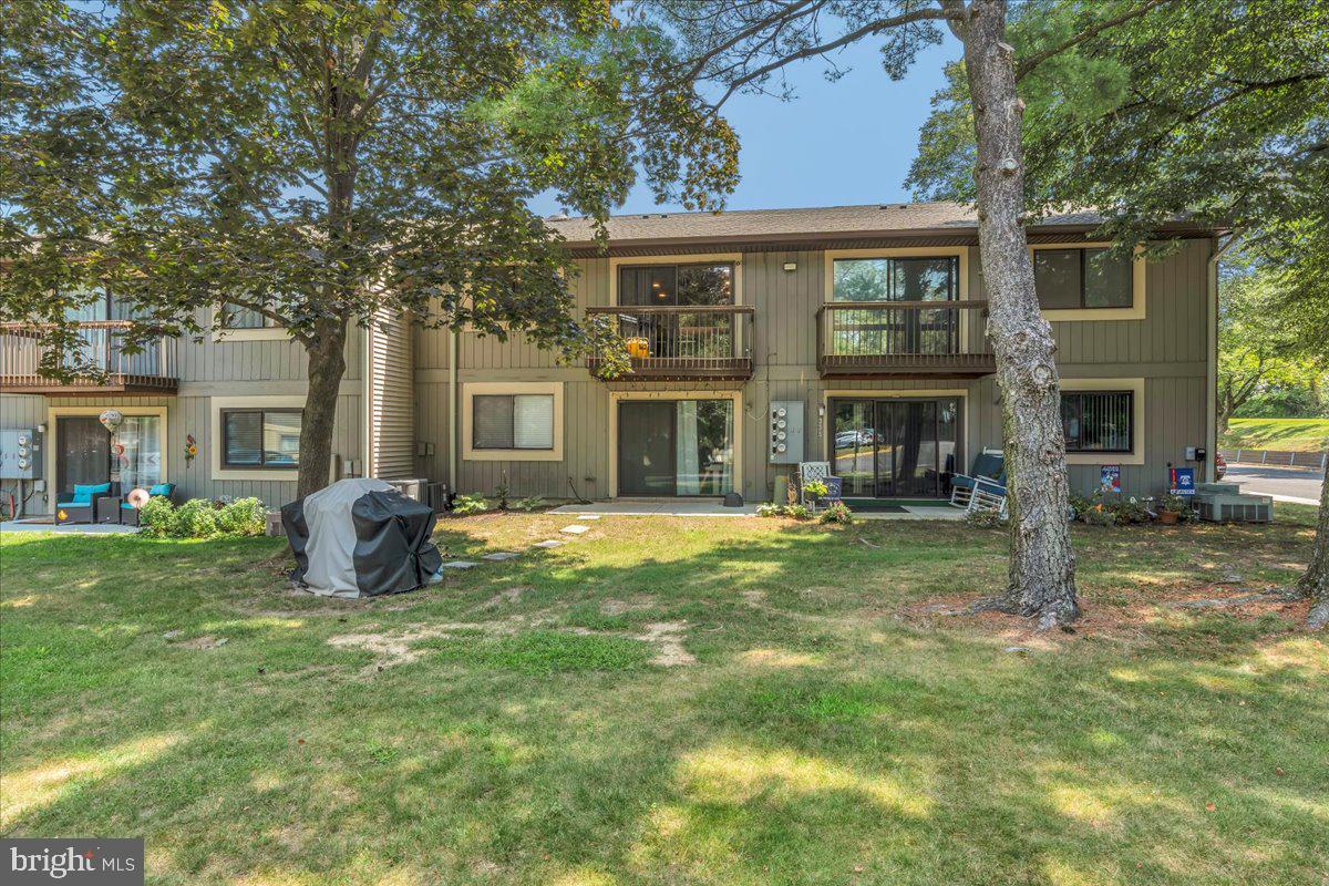 115 East Kings Highway, Unit 334 Maple Shade, NJ 08052 - Photo 21 of 26 a view of a yard in front of a brick house with a large windows