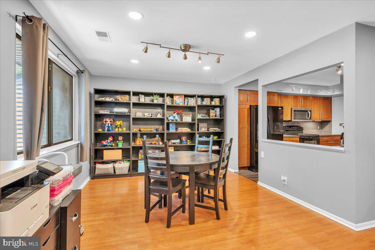 115 East Kings Highway, Unit 334 Maple Shade, NJ 08052 - Photo 24 of 26 a view of a dining room with furniture and a book shelf
