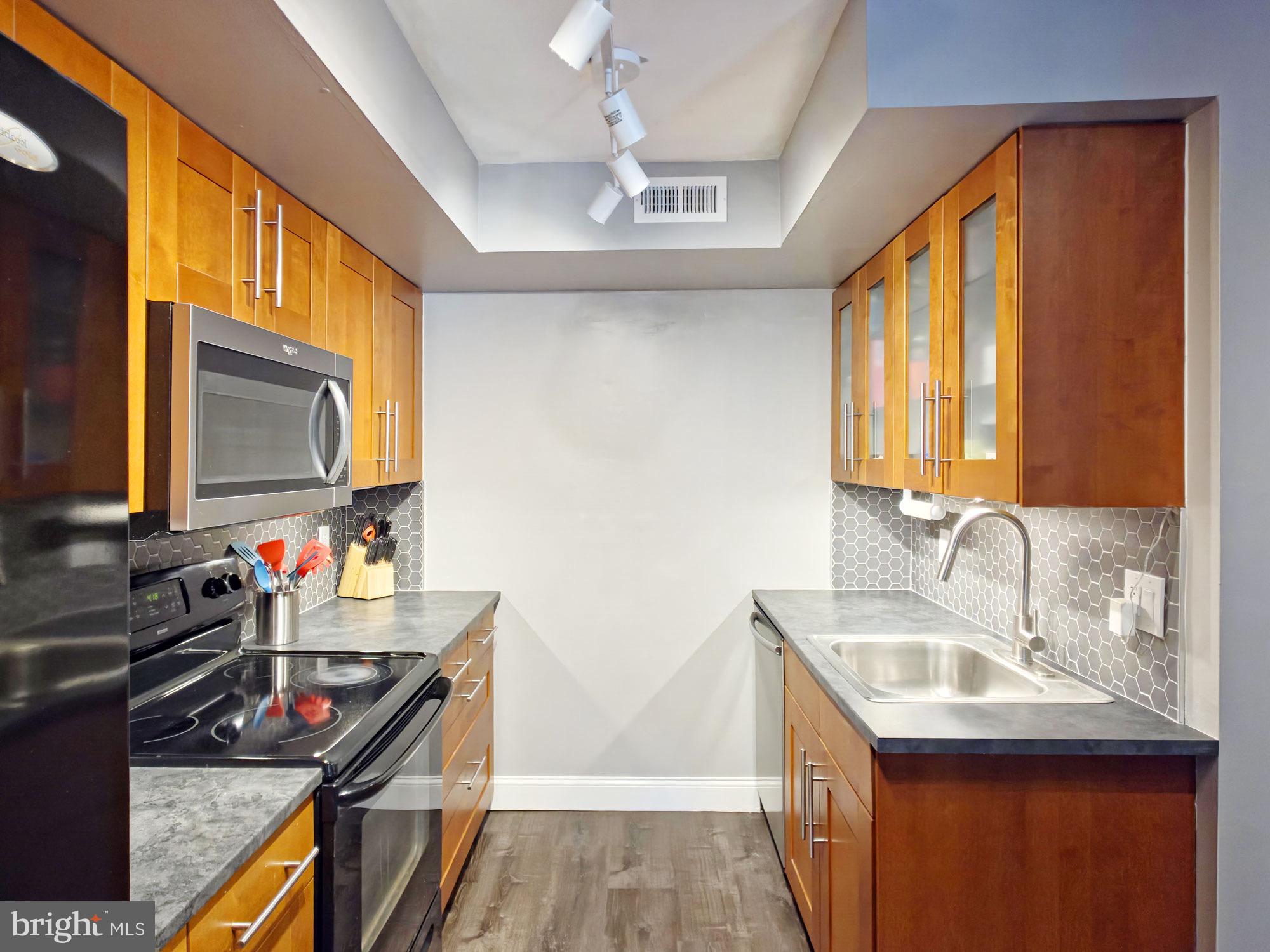 115 East Kings Highway, Unit 334 Maple Shade, NJ 08052 - Photo 25 of 26 a bathroom with a sink a mirror and a bathtub