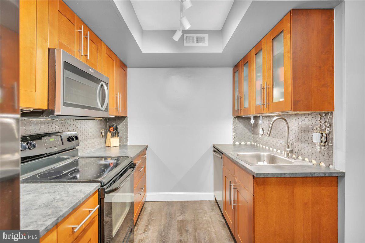 115 East Kings Highway, Unit 334 Maple Shade, NJ 08052 - Photo 5 of 26 a kitchen with stainless steel appliances granite countertop a sink a stove and a refrigerator
