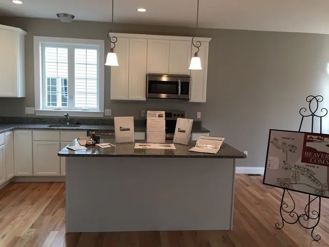 a kitchen with stainless steel appliances a sink stove and microwave