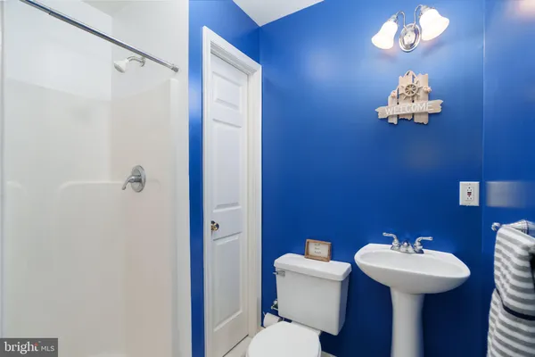 a bathroom with a sink mirror and toilet