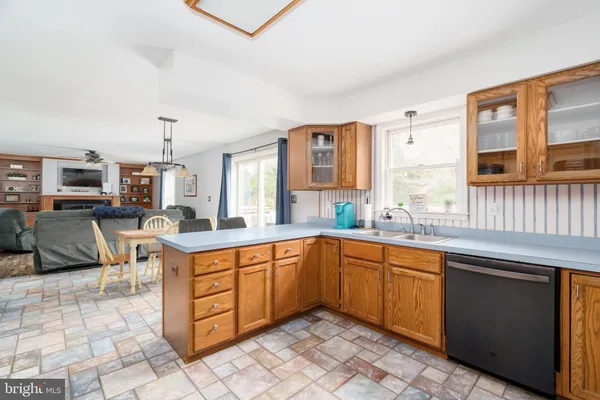 a open kitchen with stainless steel appliances granite countertop a sink and cabinets