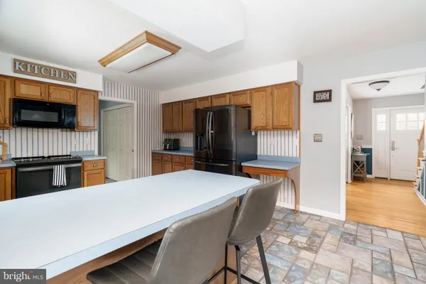 a view of kitchen with kitchen island and windows