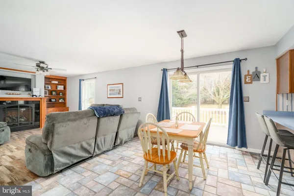 a dining room with furniture a chandelier and wooden floor
