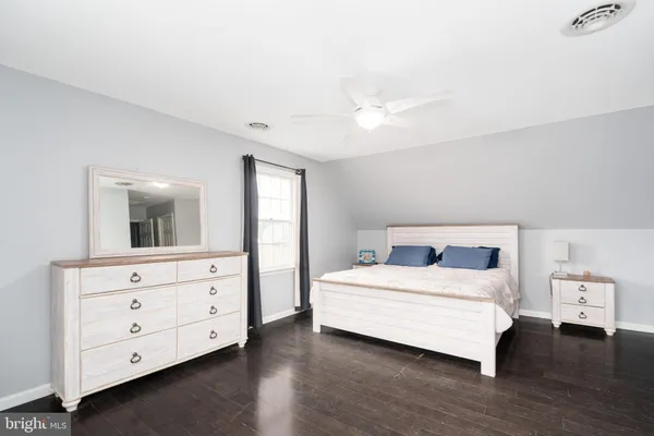 a bedroom with a bed and a dresser