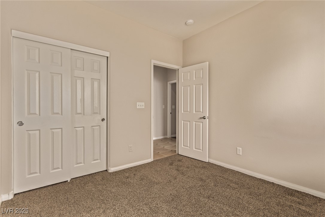6224 Boulder Rise Street Las Vegas, NV 89115 - Photo 20 of 26 Unfurnished bedroom featuring carpet floors and a closet