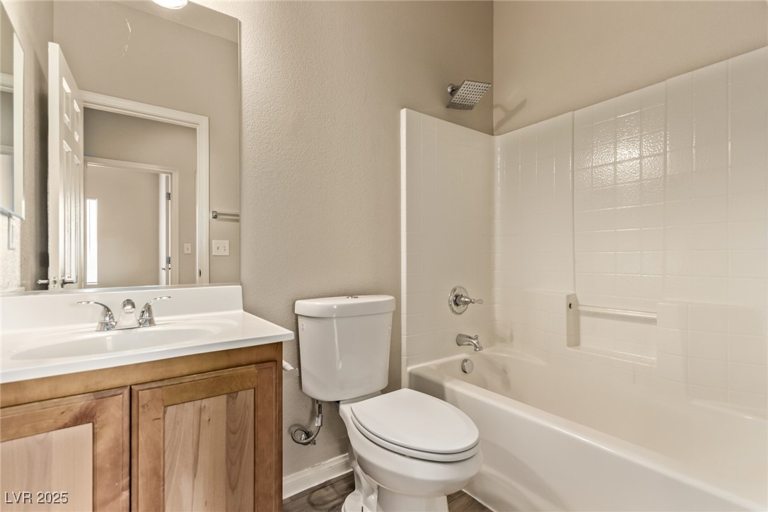 6224 Boulder Rise Street Las Vegas, NV 89115 - Photo 23 of 26 Bathroom with shower / bathtub combination, a textured wall, and vanity