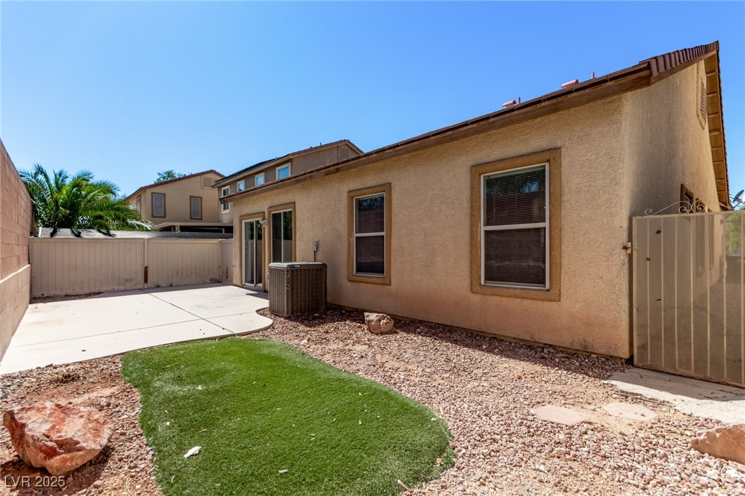 6224 Boulder Rise Street Las Vegas, NV 89115 - Photo 25 of 26 Back of house with a fenced backyard, stucco siding, and a gate