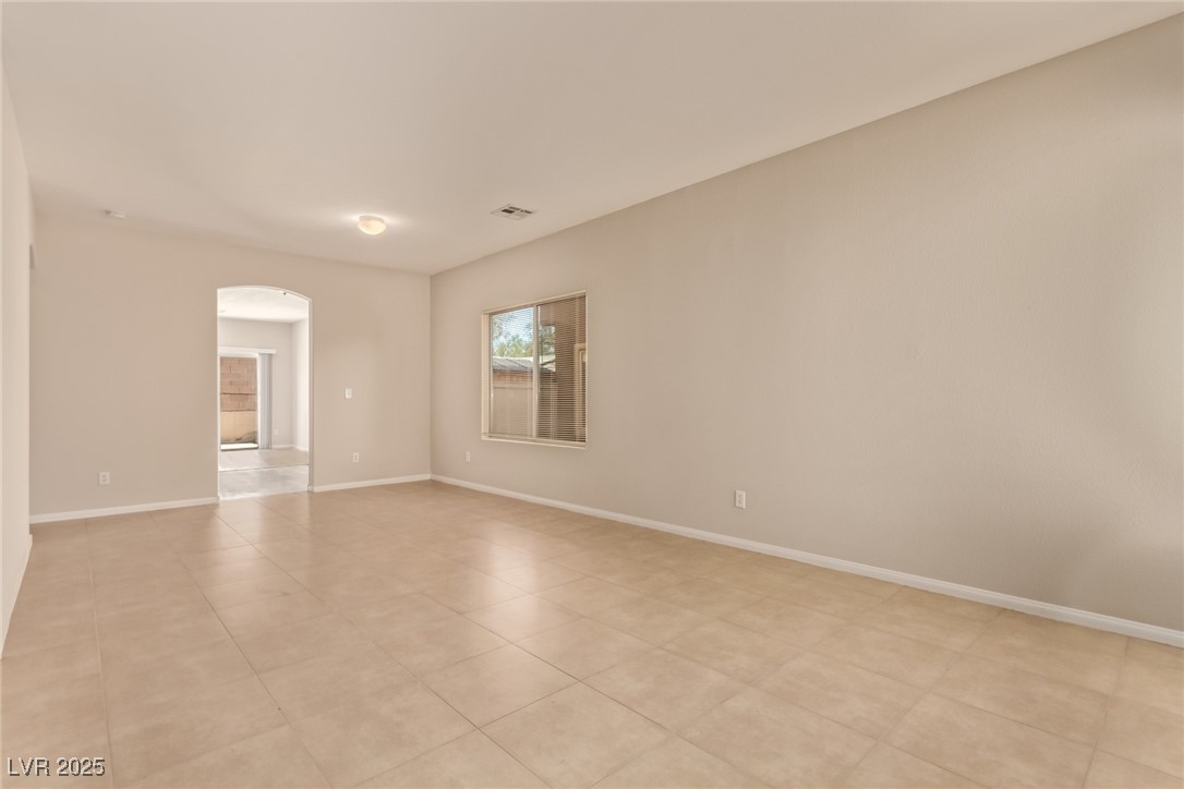 6224 Boulder Rise Street Las Vegas, NV 89115 - Photo 5 of 26 Spare room with arched walkways and baseboards