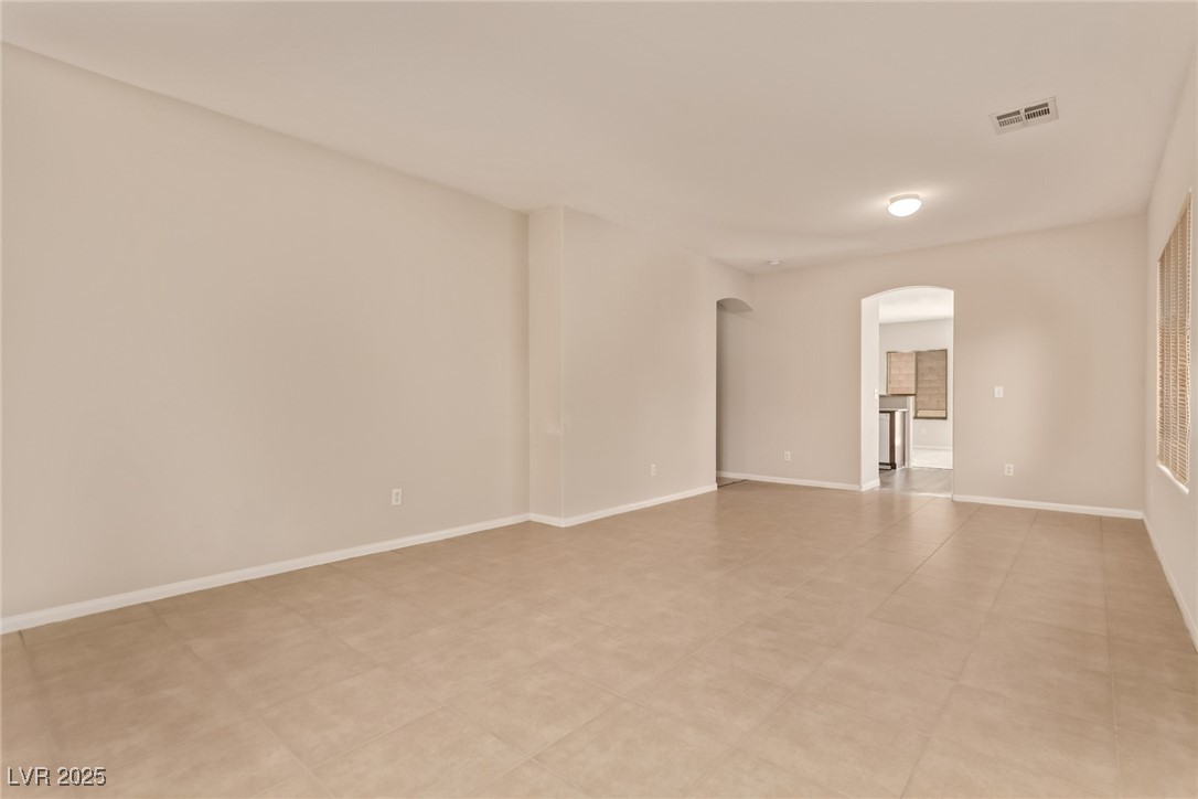 6224 Boulder Rise Street Las Vegas, NV 89115 - Photo 6 of 26 Unfurnished room featuring arched walkways and baseboards