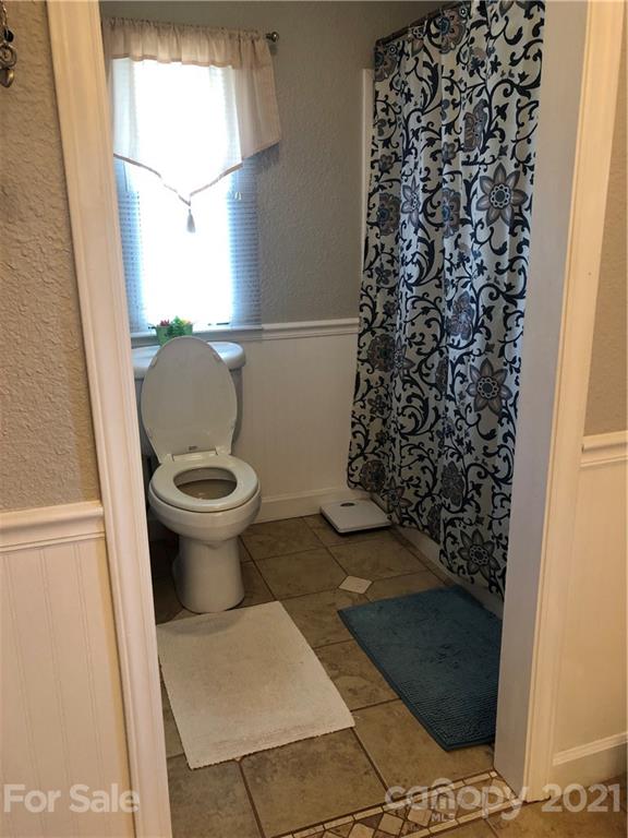 3485 Organ Church Road Rockwell, NC 28138 - Photo 12 of 33 a bathroom with a toilet and a shower curtain