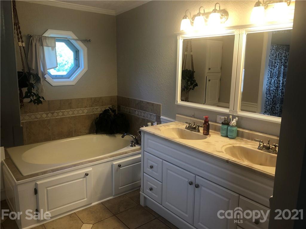 3485 Organ Church Road Rockwell, NC 28138 - Photo 14 of 33 a bathroom with a sink and a mirror
