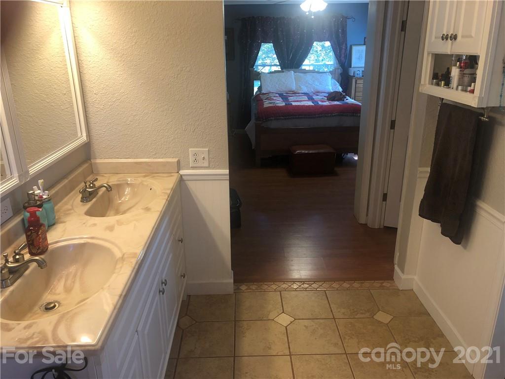 3485 Organ Church Road Rockwell, NC 28138 - Photo 15 of 33 a bathroom with a tub sink and mirror