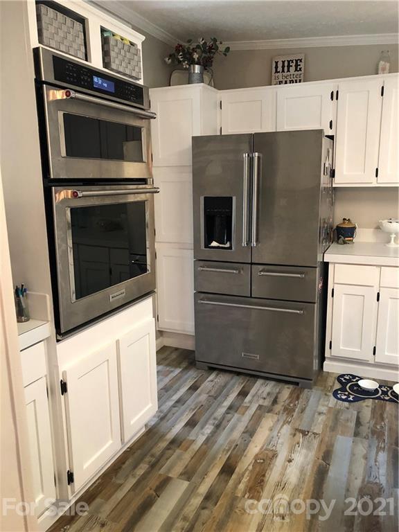 3485 Organ Church Road Rockwell, NC 28138 - Photo 3 of 33 a kitchen with granite countertop white cabinets and stainless steel appliances