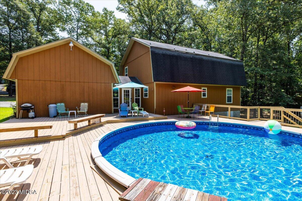 222 Red Oak Road Byron, GA 31008 - Photo 26 of 38 a view of swimming pool with a lounge chair and potted plants