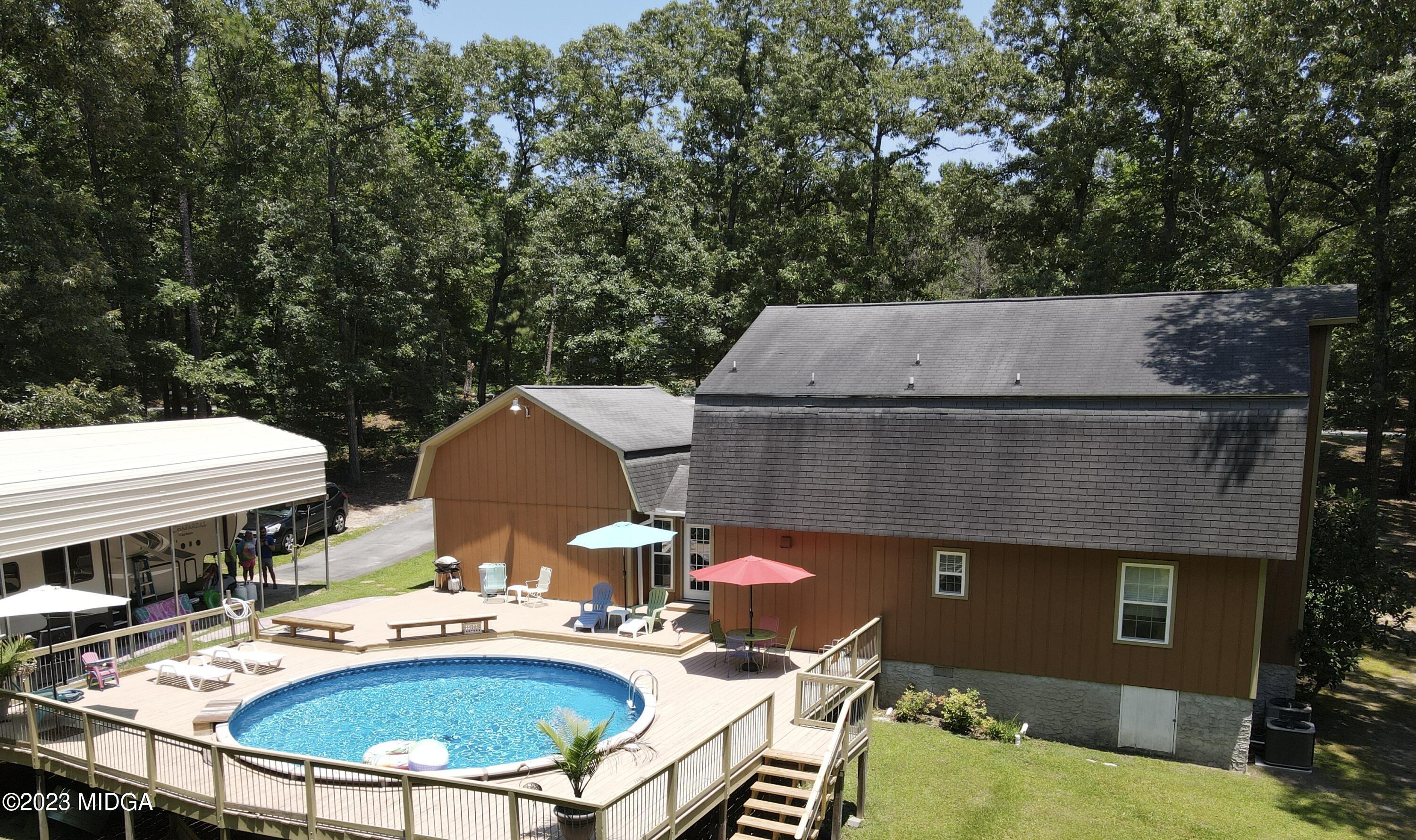 222 Red Oak Road Byron, GA 31008 - Photo 28 of 38 an aerial view of a house with swimming pool and outdoor seating