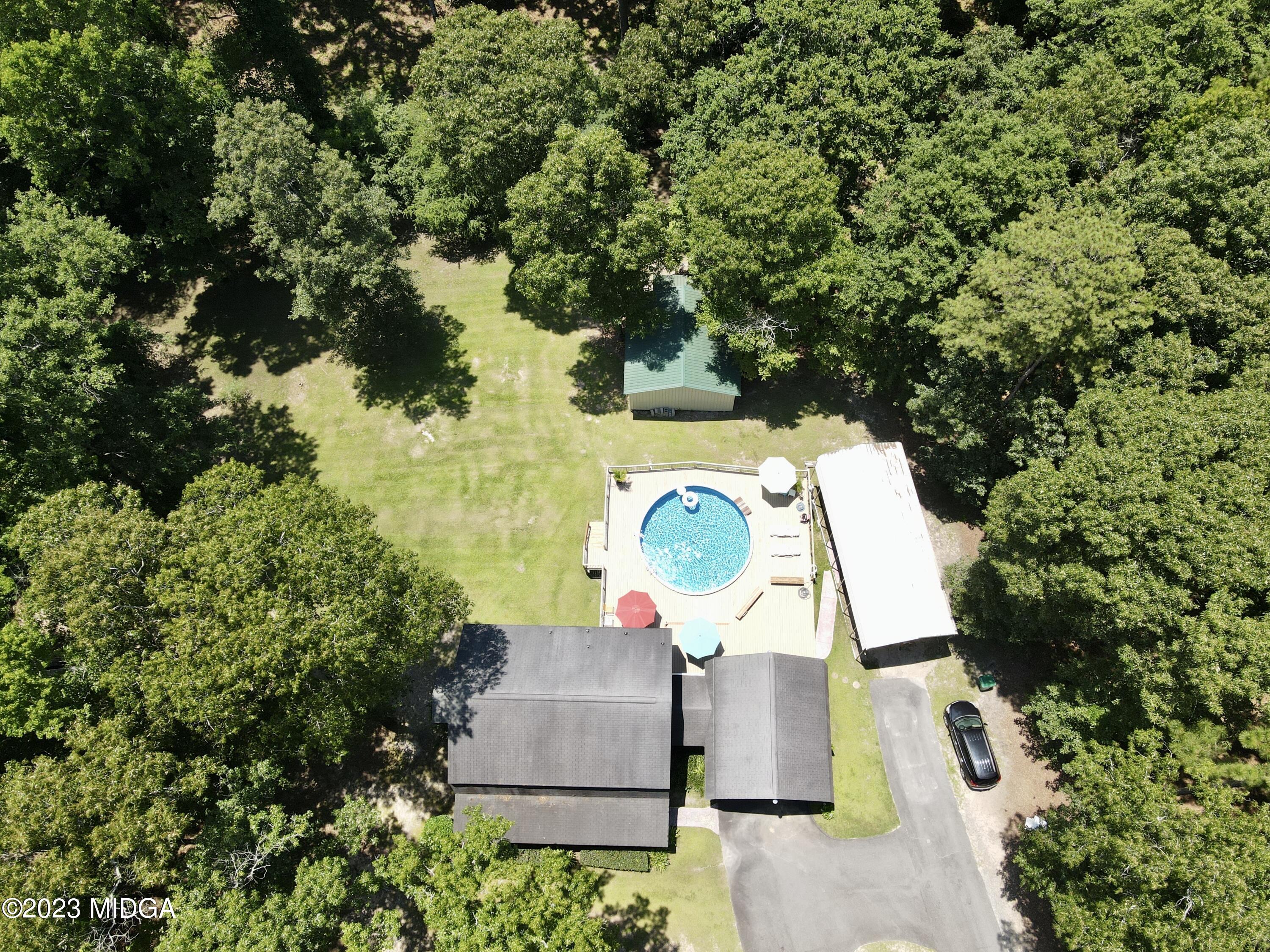 222 Red Oak Road Byron, GA 31008 - Photo 3 of 38 an aerial view of a house with a yard and swimming pool
