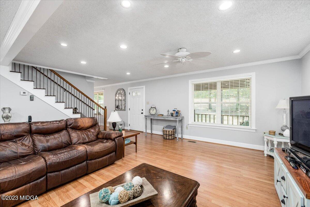 222 Red Oak Road Byron, GA 31008 - Photo 4 of 38 a living room with furniture a fireplace and a flat screen tv