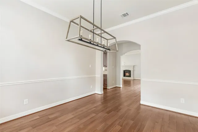 a view of a room with wooden floor entryway and a ceiling fan