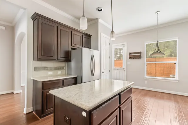 a kitchen with a table chairs and refrigerator