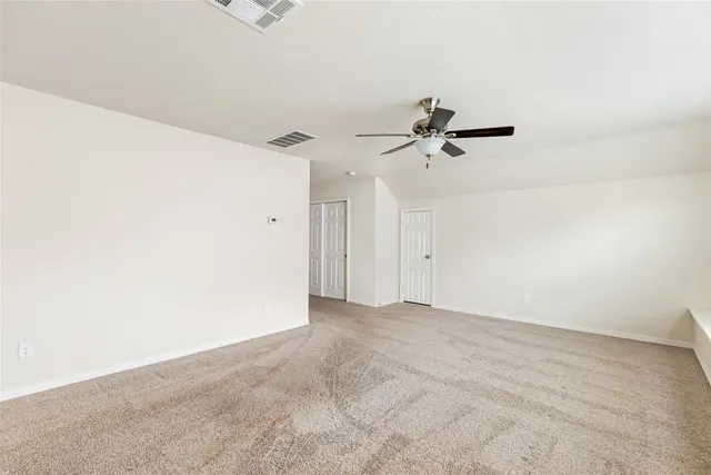 a view of a room with a ceiling fan