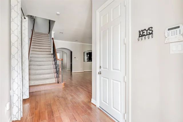 a view of a hallway with wooden floor and entryway