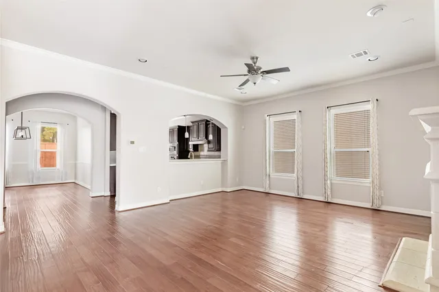 a view of empty room with wooden floor and fireplace