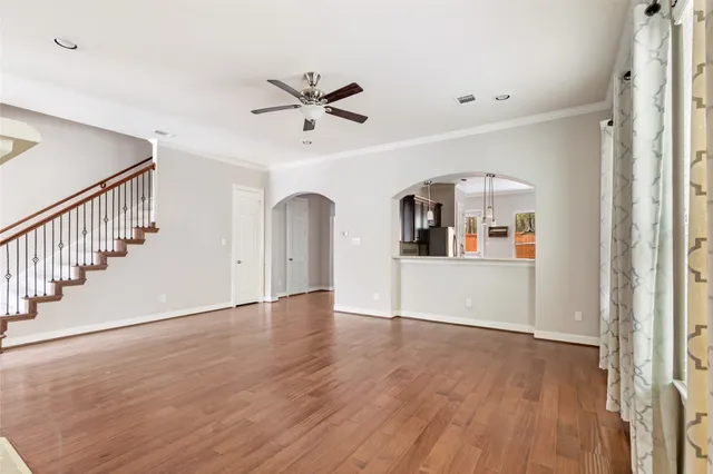 a view of a livingroom with wooden floor and entryway