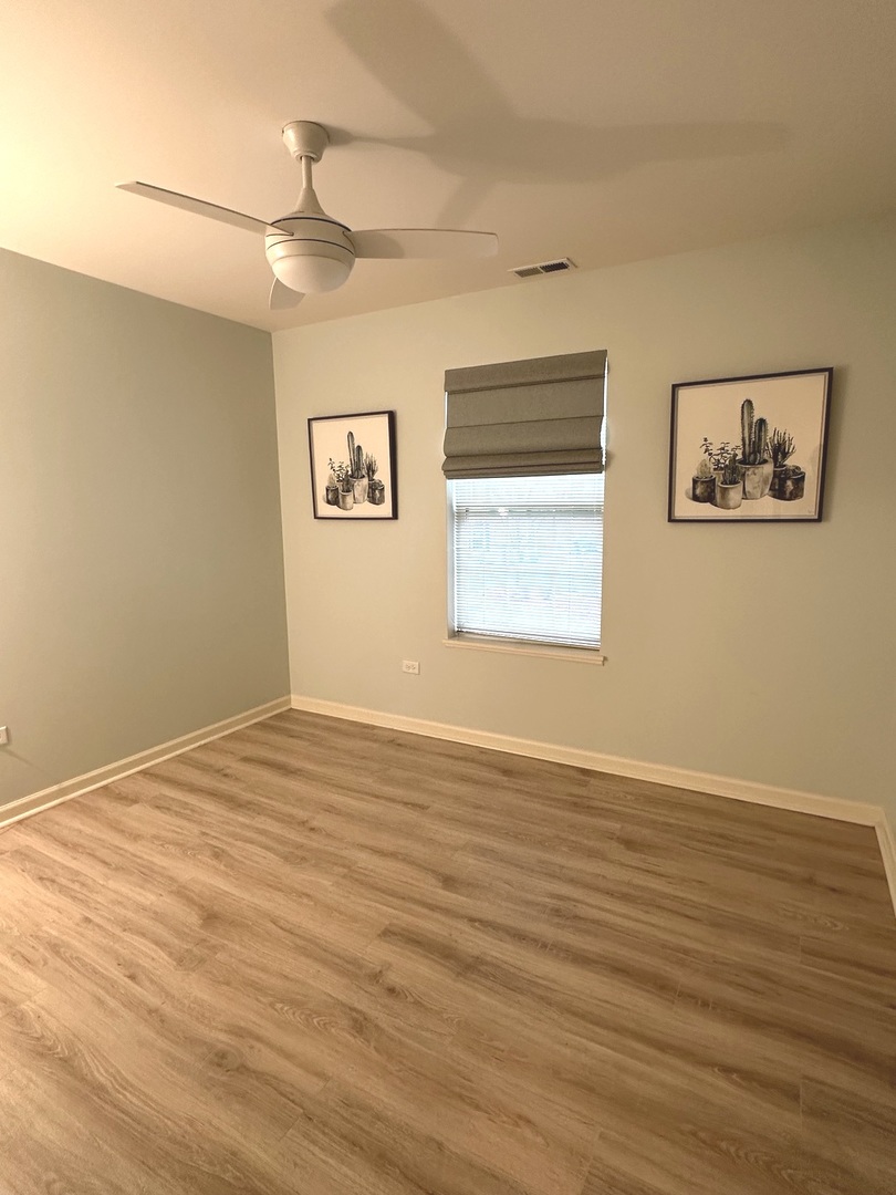 5102 Monroe Street Matteson, IL 60443 - Photo 40 of 54 a view of an empty room with wooden floor and a window