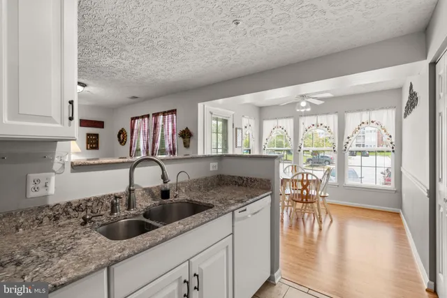 a kitchen with a sink and a large window
