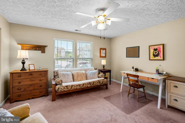 a bed room with a bed table and a window