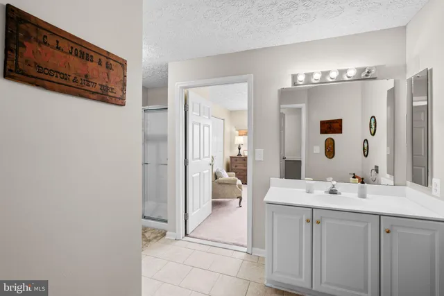 a spacious bathroom with a double vanity sink and a mirror