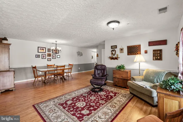 a living room with furniture rug and a table