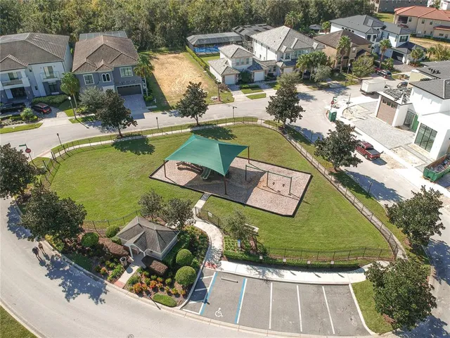an aerial view of residential houses with outdoor space and swimming pool