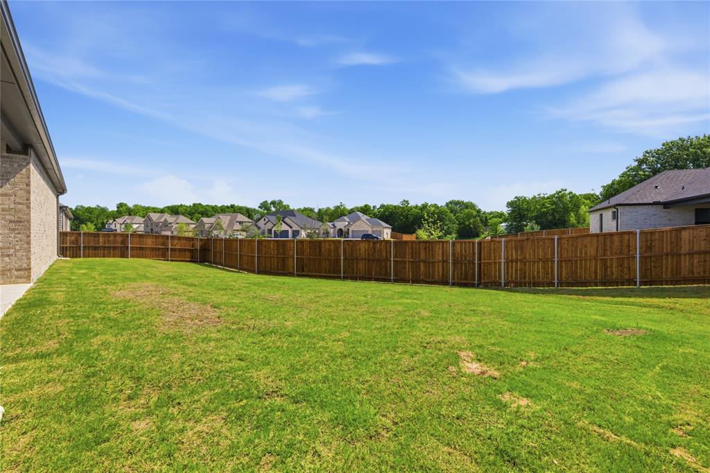 709 Anne Road Van Alstyne, TX 75495 - Photo 26 of 28 Expansive grassy yard area featuring a full privacy fence