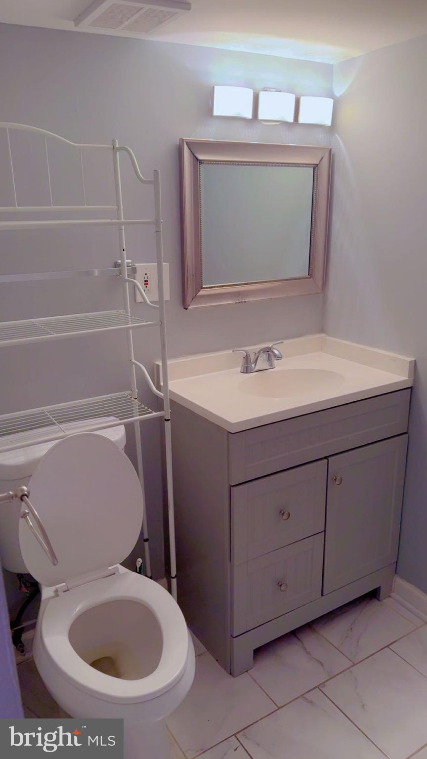 3300 Yellow Flower Road Laurel, MD 20724 - Photo 17 of 20 a bathroom with a toilet sink and mirror