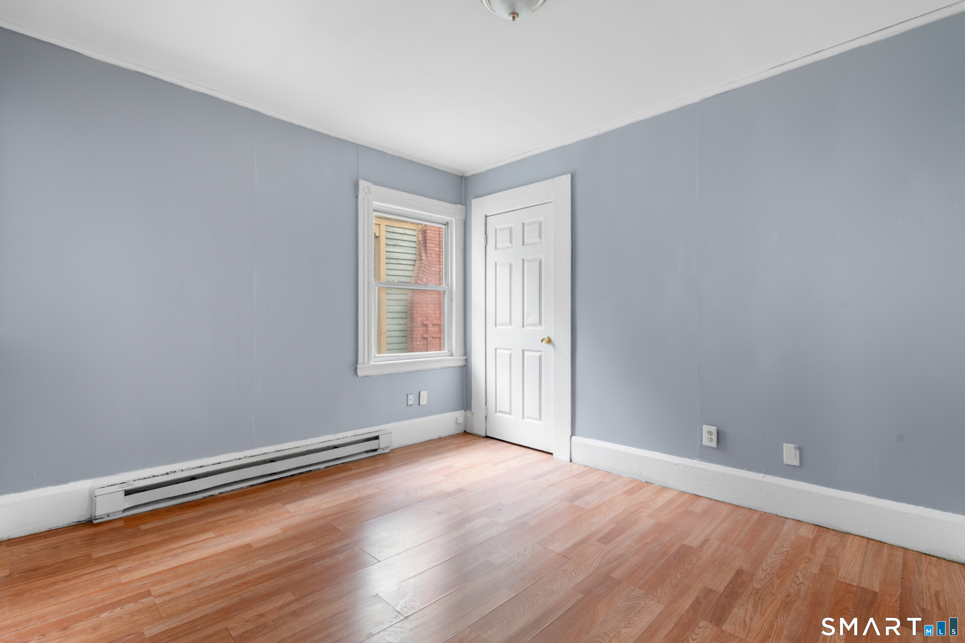 135 Prospect Street Waterbury, CT 06710 - Photo 13 of 19 an empty room with wooden floor and windows