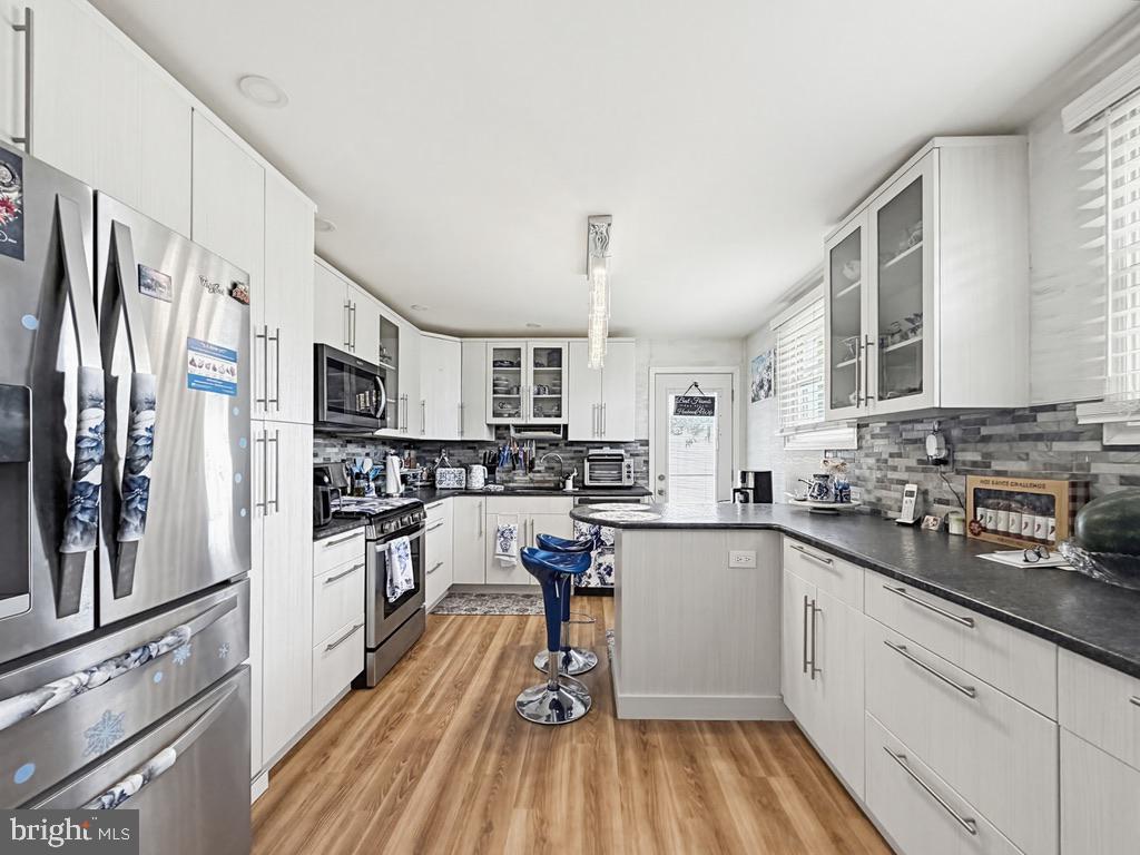 254 Allen Lane Warminster, PA 18974 - Photo 19 of 85 a kitchen with stainless steel appliances a refrigerator sink and white cabinets