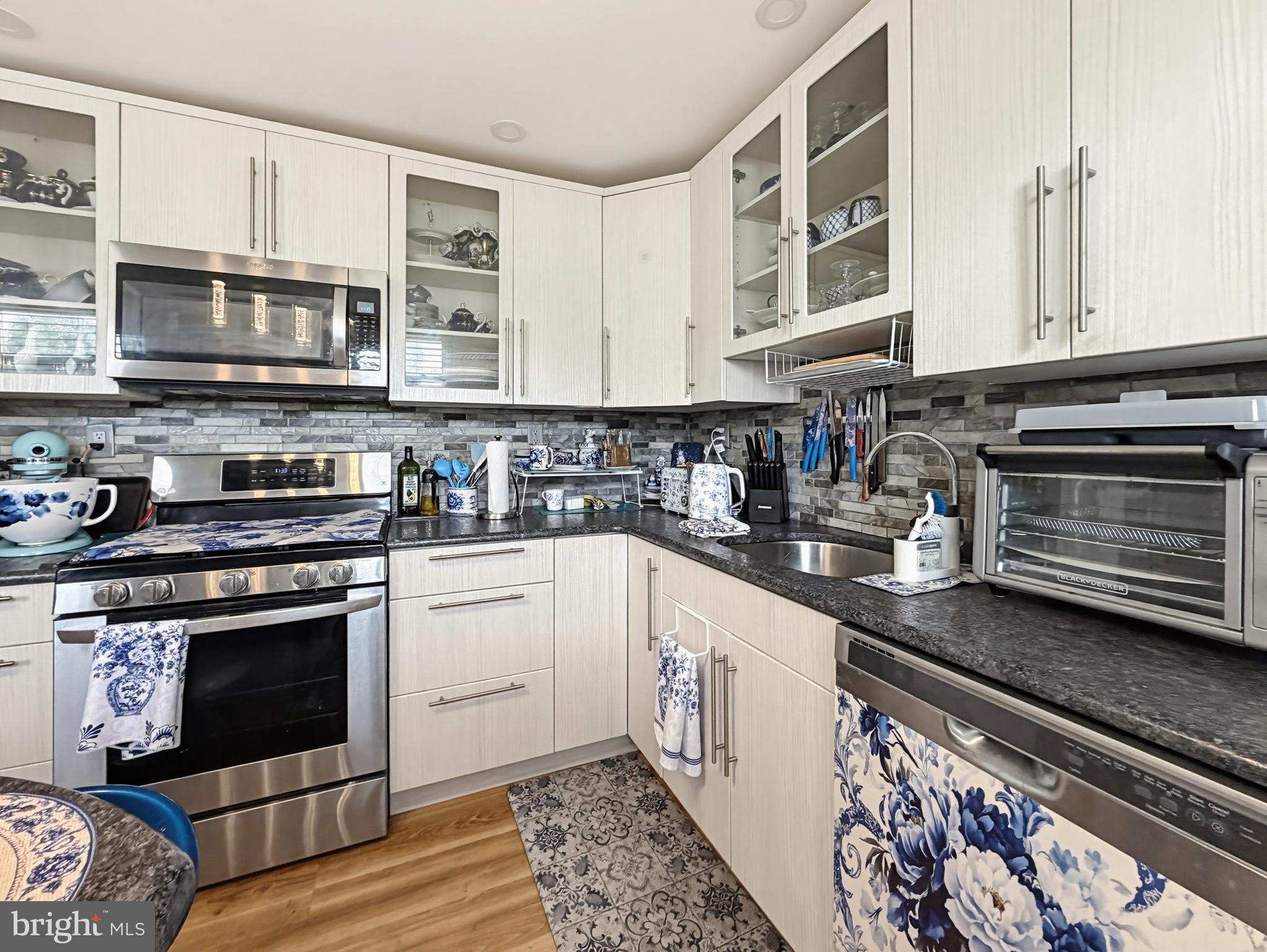254 Allen Lane Warminster, PA 18974 - Photo 21 of 85 a kitchen with stainless steel appliances granite countertop a stove and a microwave