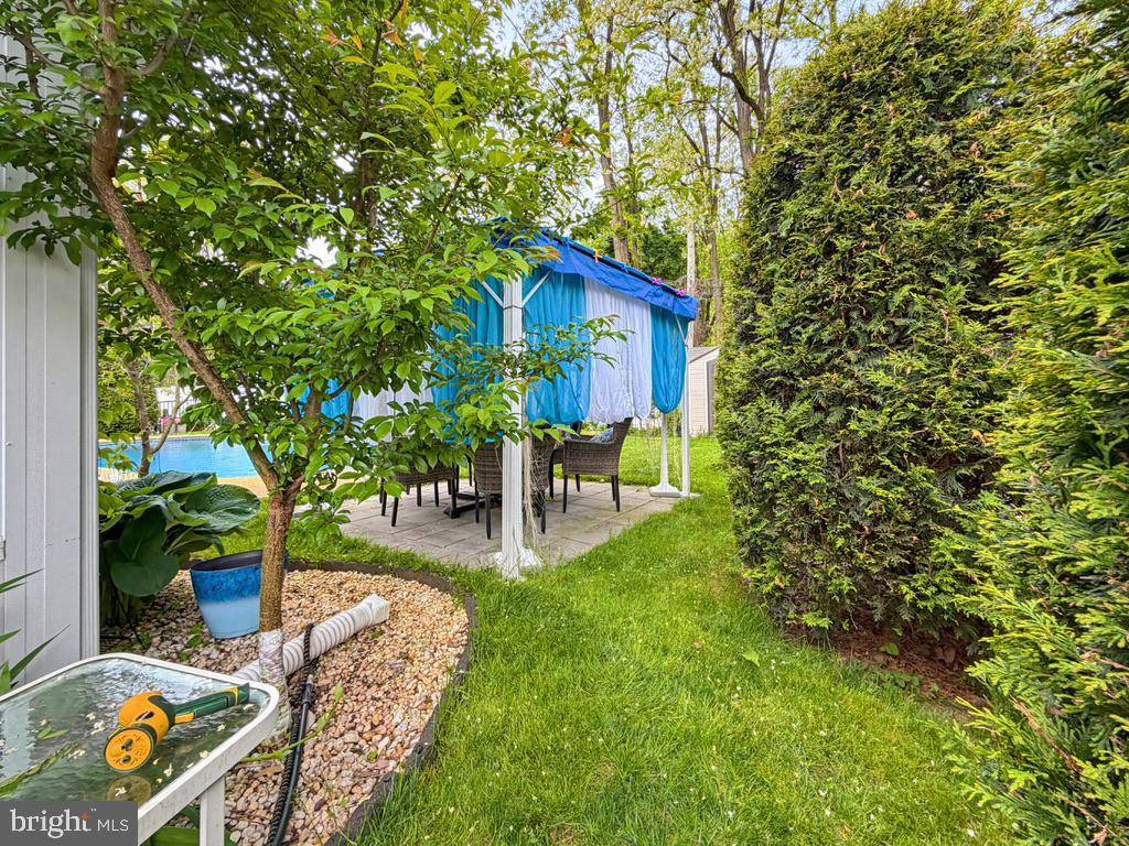 254 Allen Lane Warminster, PA 18974 - Photo 82 of 85 a view of a backyard with table and chairs and potted plants