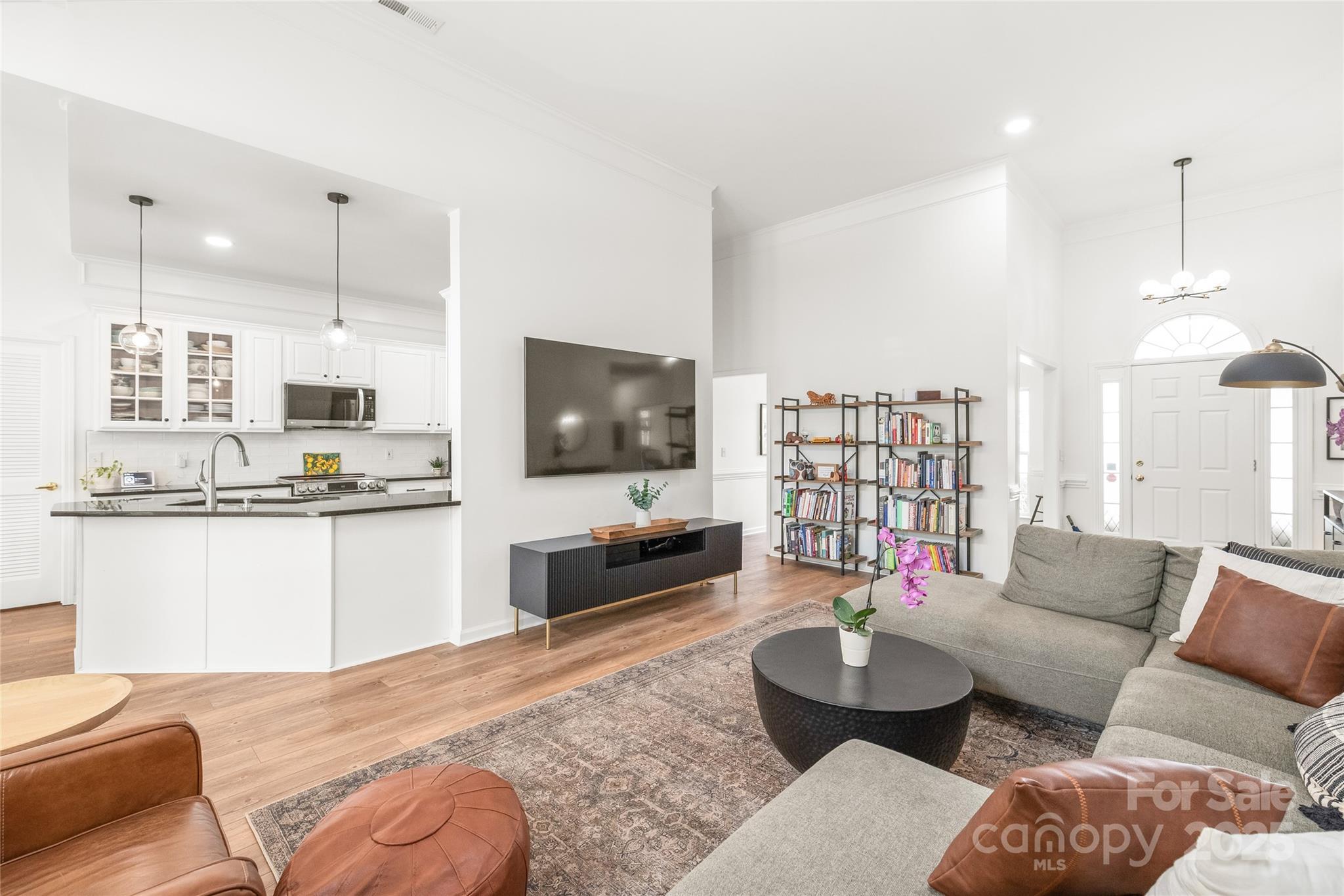502 Roxanne Court Northwest Concord, NC 28027 - Photo 13 of 40 a living room with furniture flat screen tv and kitchen view