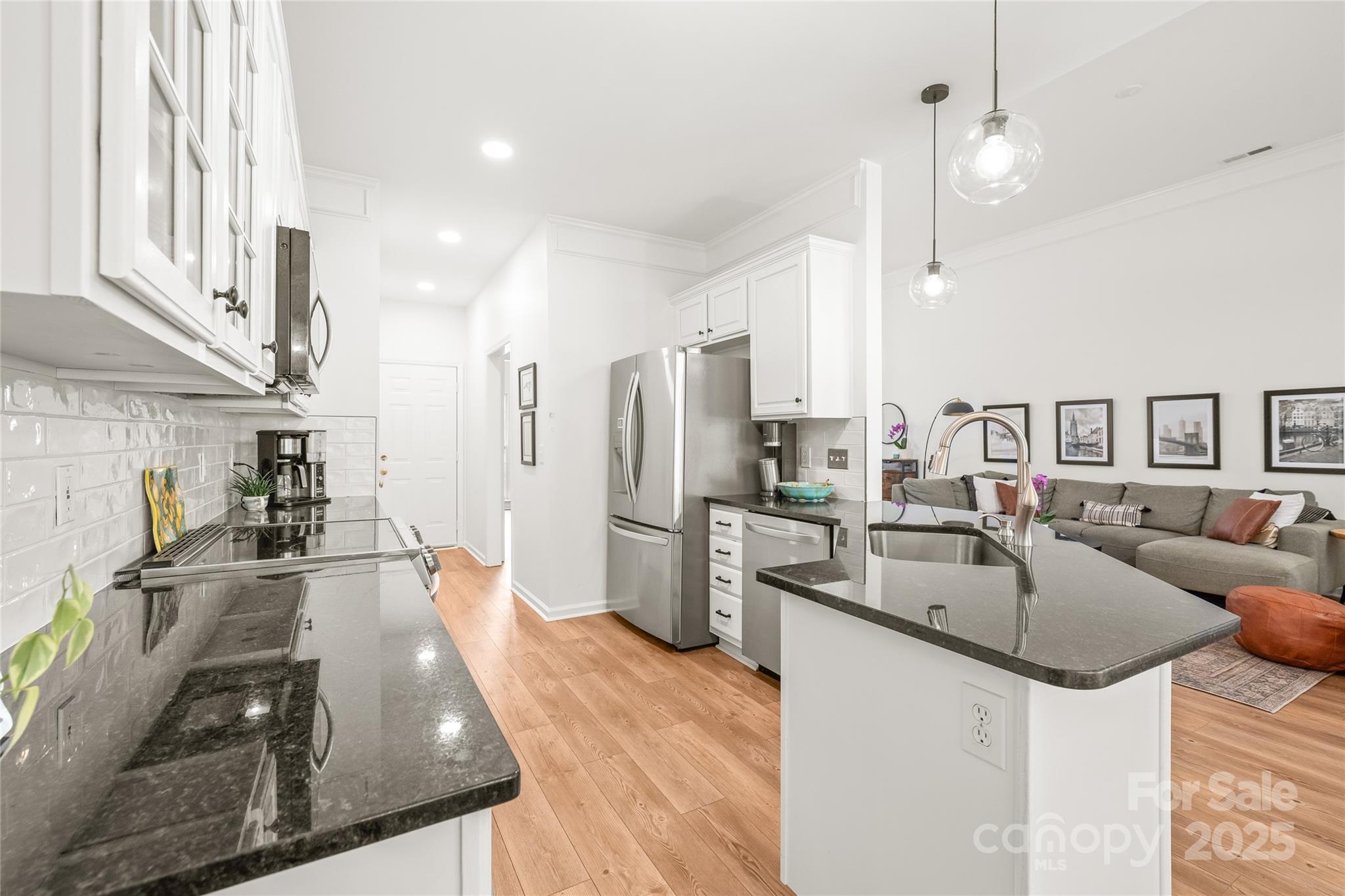 502 Roxanne Court Northwest Concord, NC 28027 - Photo 16 of 40 a kitchen with stainless steel appliances granite countertop a sink stove and refrigerator