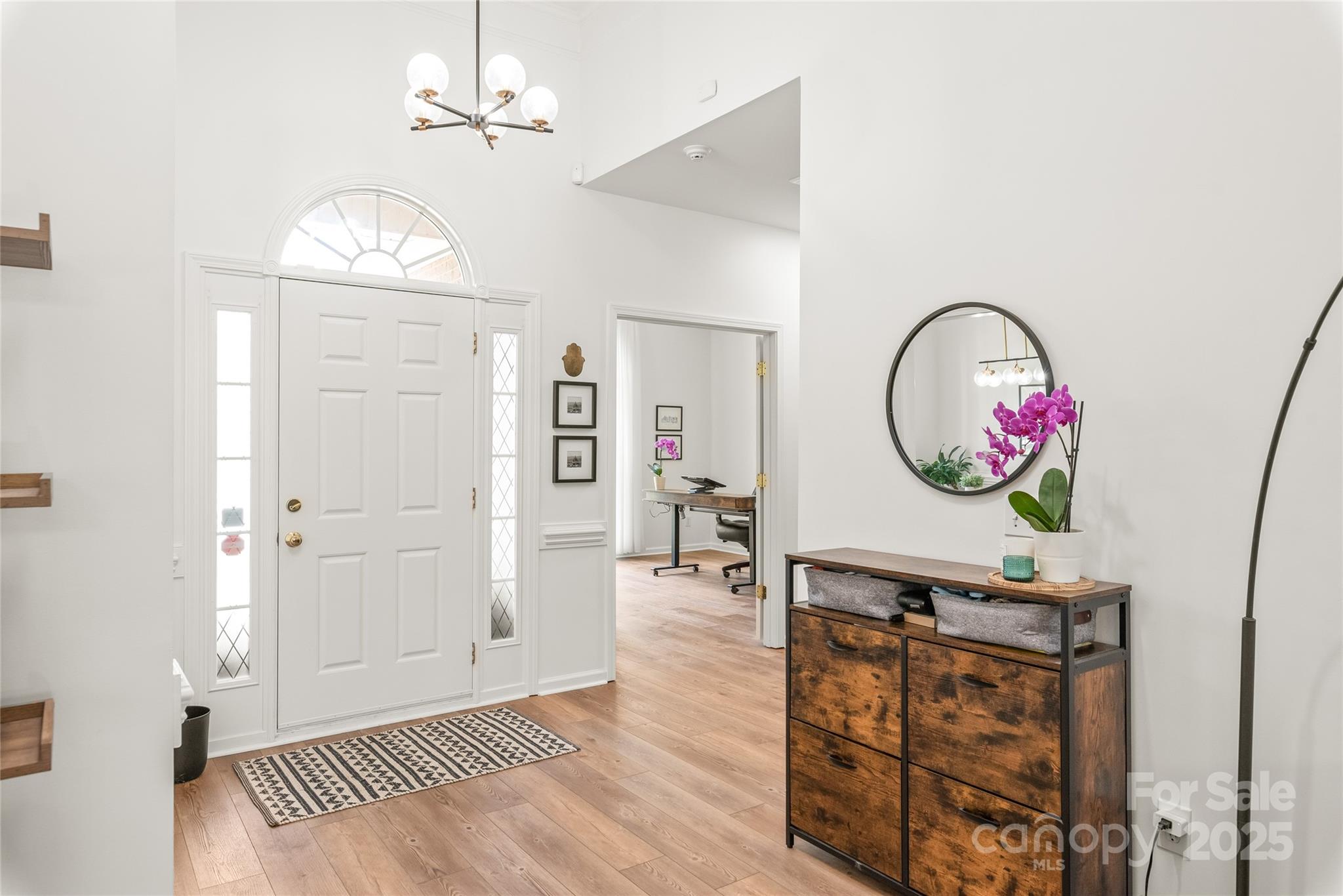 502 Roxanne Court Northwest Concord, NC 28027 - Photo 19 of 40 a view of a hallway with wooden floor and a chandelier