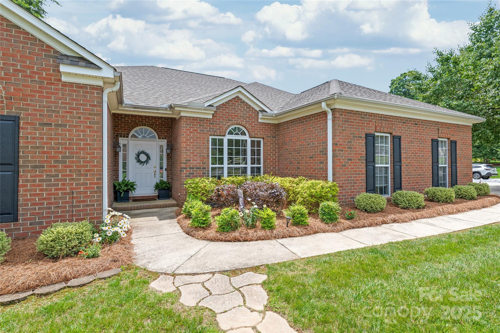 502 Roxanne Court Northwest Concord, NC 28027 - Photo 3 of 40 a front view of a house with a yard and potted plants