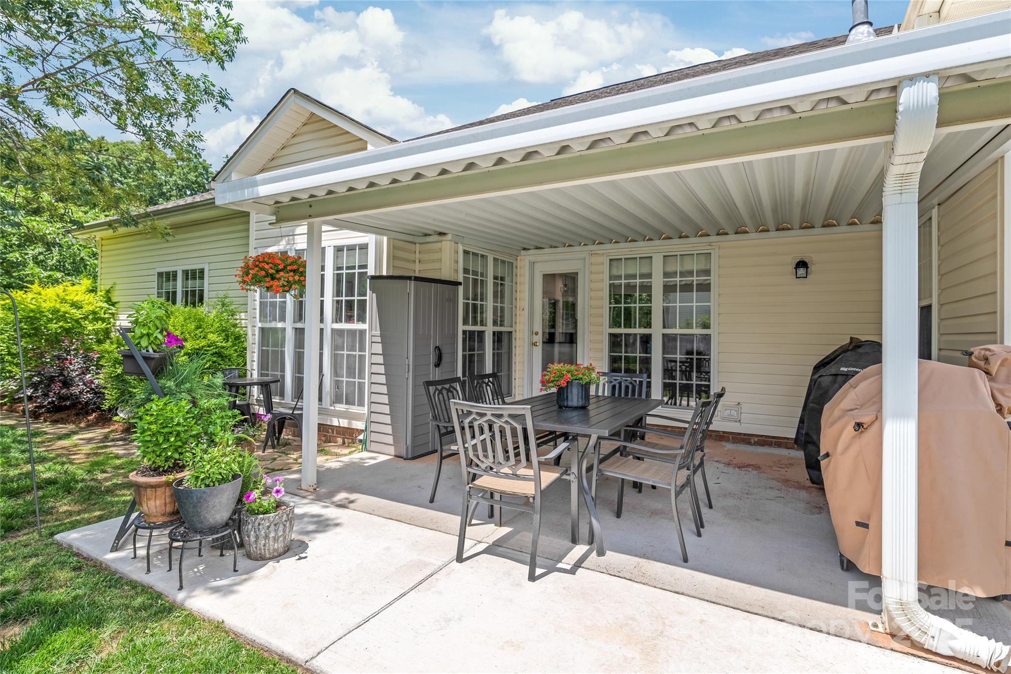 502 Roxanne Court Northwest Concord, NC 28027 - Photo 34 of 40 a patio with a table and chairs and potted plants