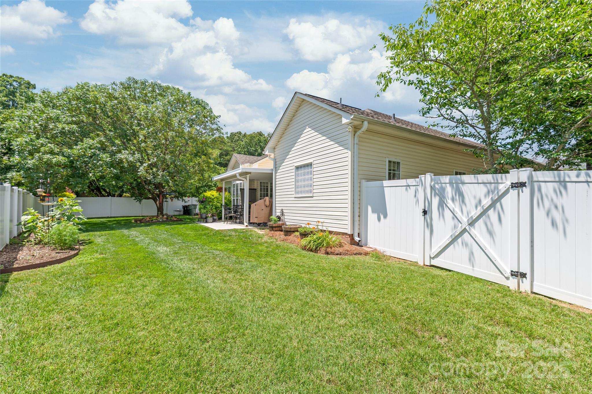 502 Roxanne Court Northwest Concord, NC 28027 - Photo 38 of 40 a view of a backyard with a garden and entertaining space