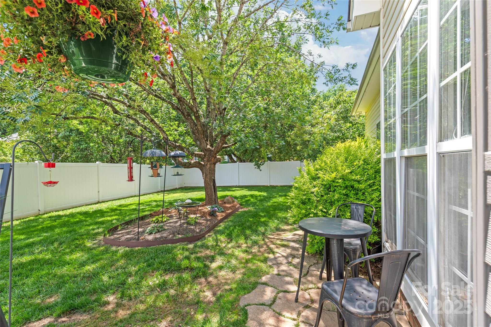 502 Roxanne Court Northwest Concord, NC 28027 - Photo 39 of 40 a backyard of a house with table and chairs and a large tree