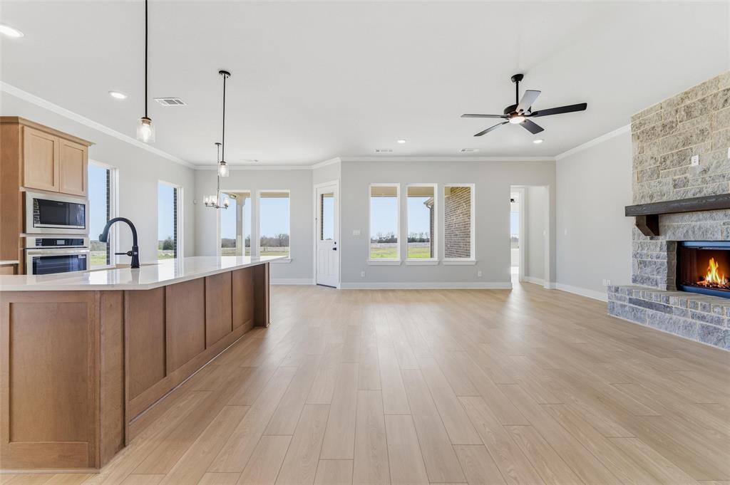 245 Cobb Road Leonard, TX 75452 - Photo 30 of 30 a view of a kitchen with a sink wooden cabinets and a fireplace
