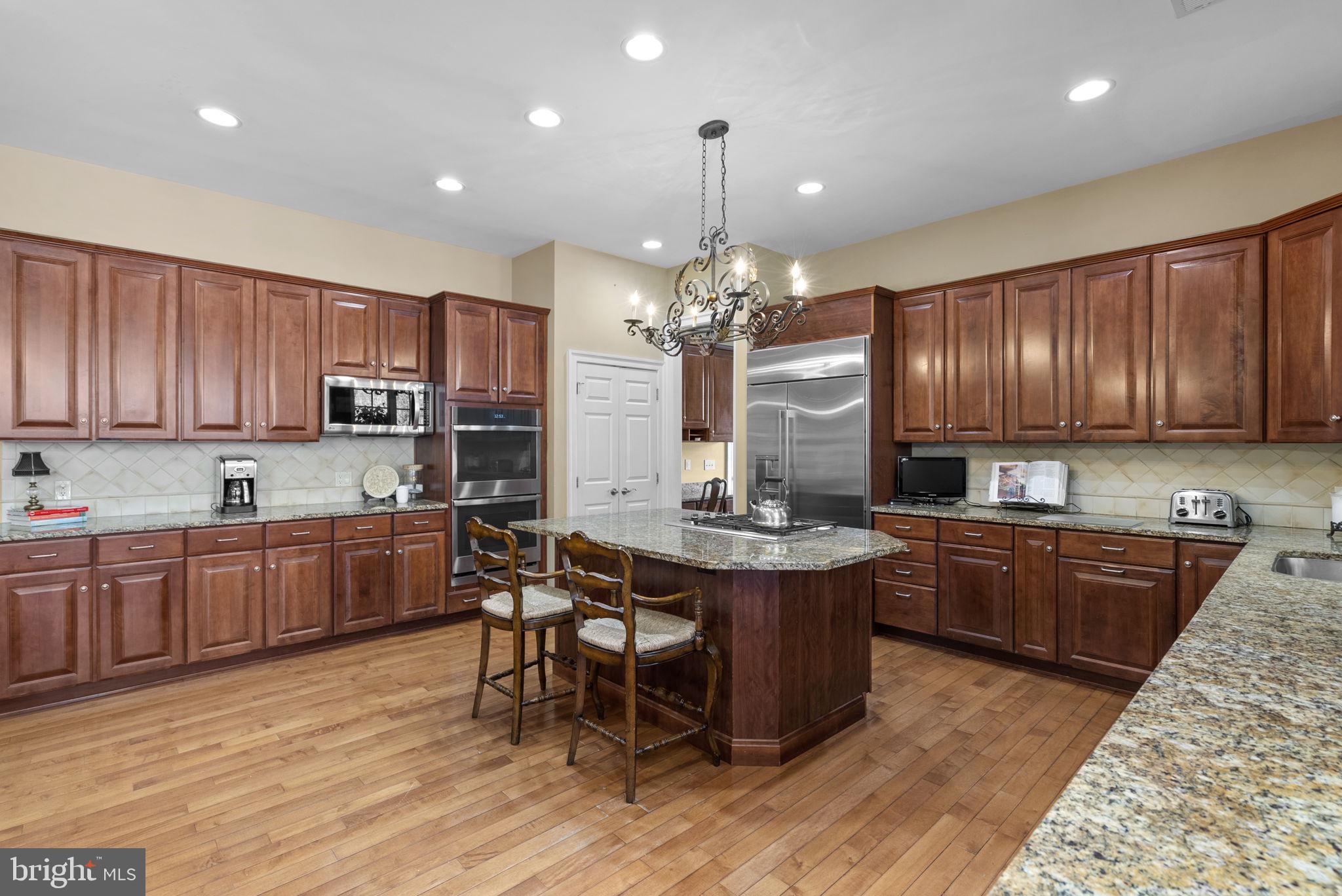 17516 Ashton Green Drive Sandy Spring, MD 20860 - Photo 22 of 60 Elegant kitchen with rich wood tones.